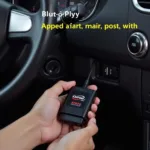 A person installing an OBD2 module in their car