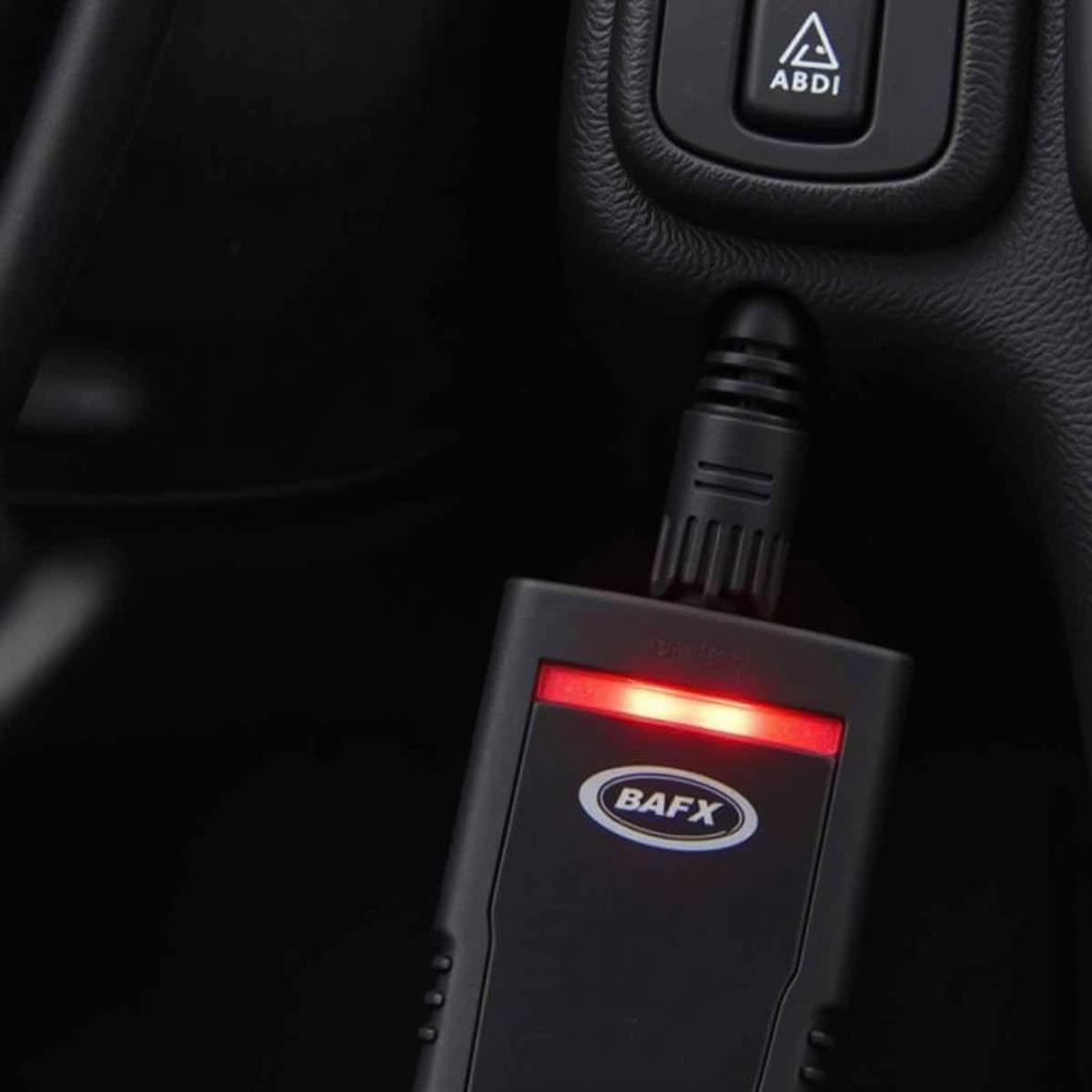 BAFX OBD2 scanner plugged into a car's OBD2 port, displaying a red light