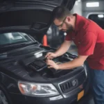 Mechanic using an OBD2 scanner to relearn a car computer