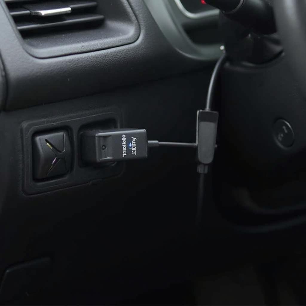 Bluetooth OBD2 adapter plugged into a car's OBD port