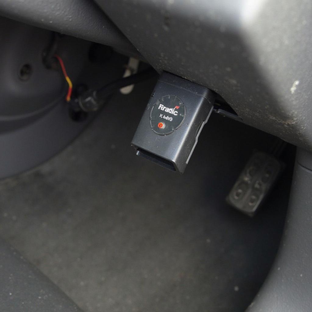 Freematics OBD2 device plugged into a car's OBD2 port