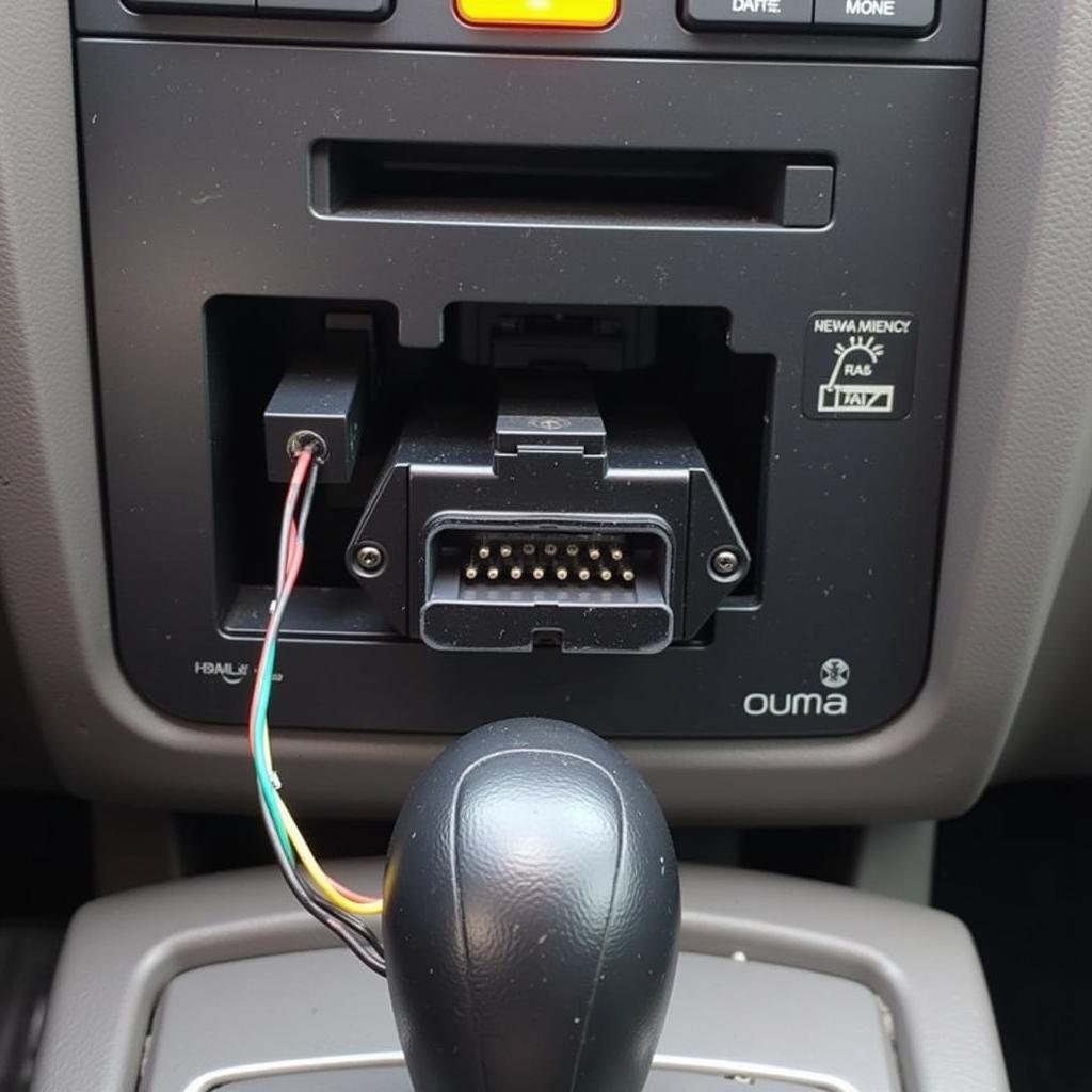 Close-up view of a Honda OBD2 connector and its wiring harness