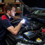 Mechanic Inspecting Engine Bay for Load PCT Issues