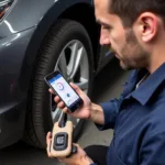 A mechanic using the OTC 3350 to diagnose a vehicle