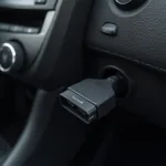 MotoSafety OBD2 device plugged into a car's OBD2 port