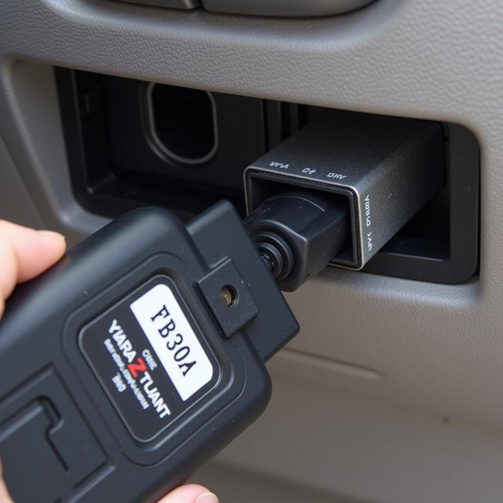 OBD2 Adapter Plugged into Car's OBD2 Port