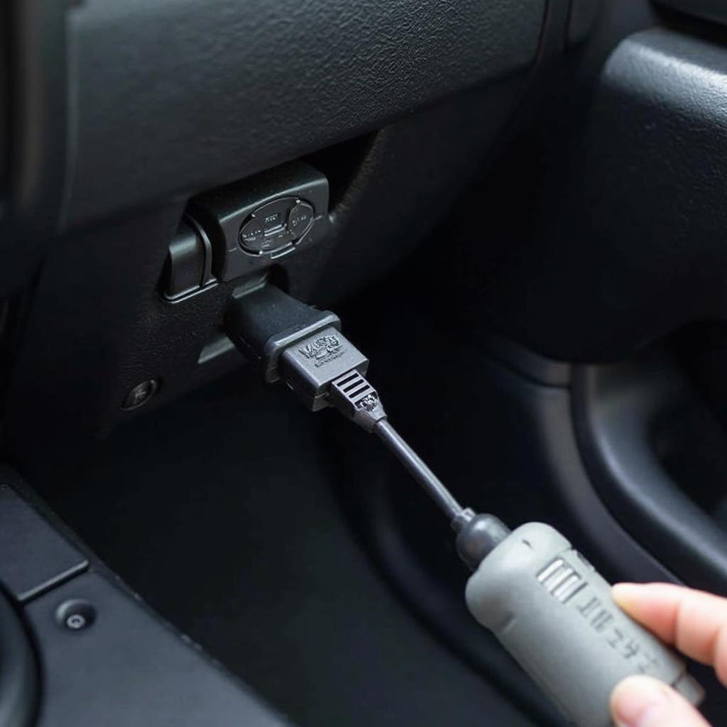 OBD2 Code Reader Cable Connected to Car