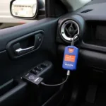 Tacklife OBD2 scanner connected to a car's OBD2 port