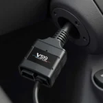 V519 OBD2 scanner plugged into a car's OBD2 port