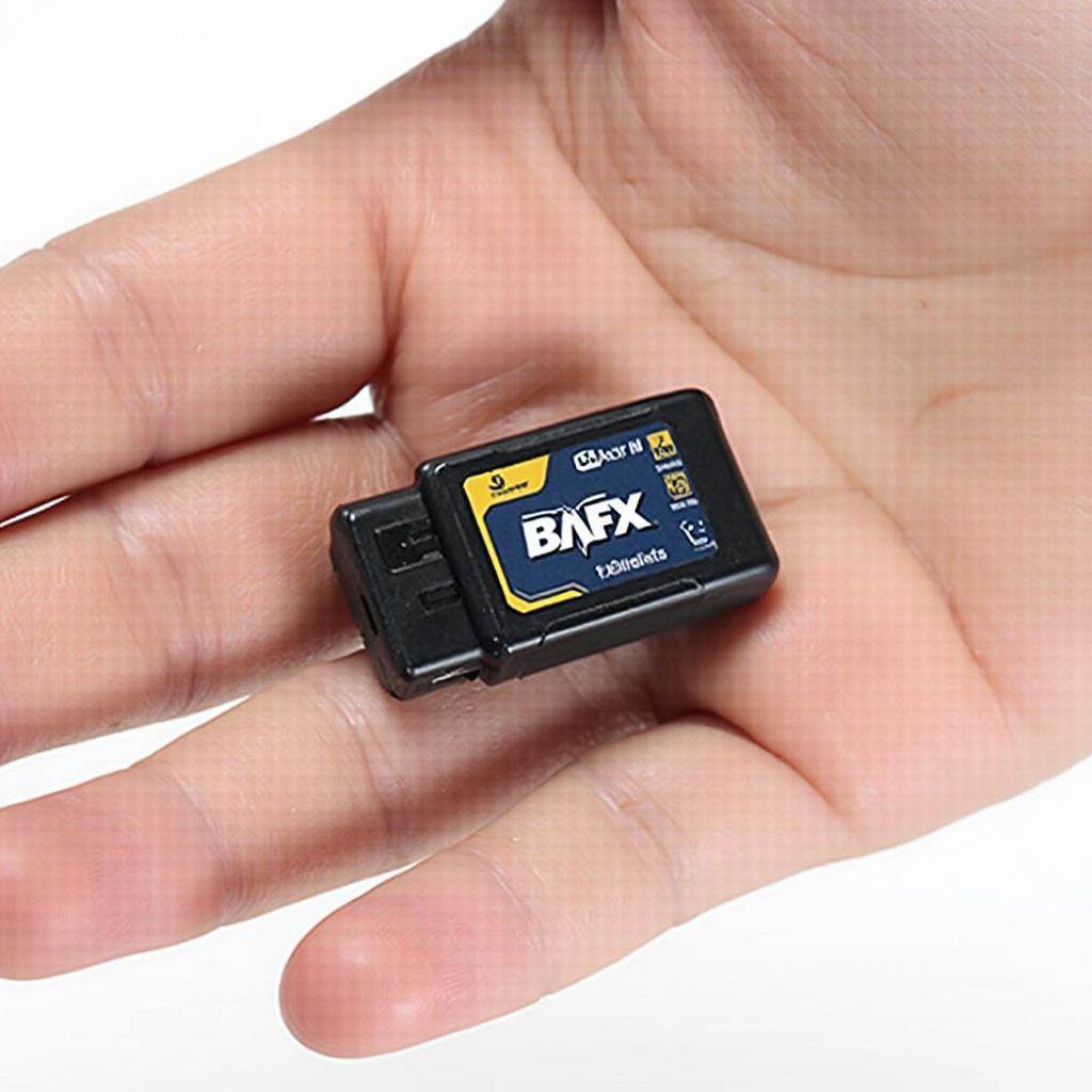 Holding a BAFX ELM327 Bluetooth OBD2 Scanner