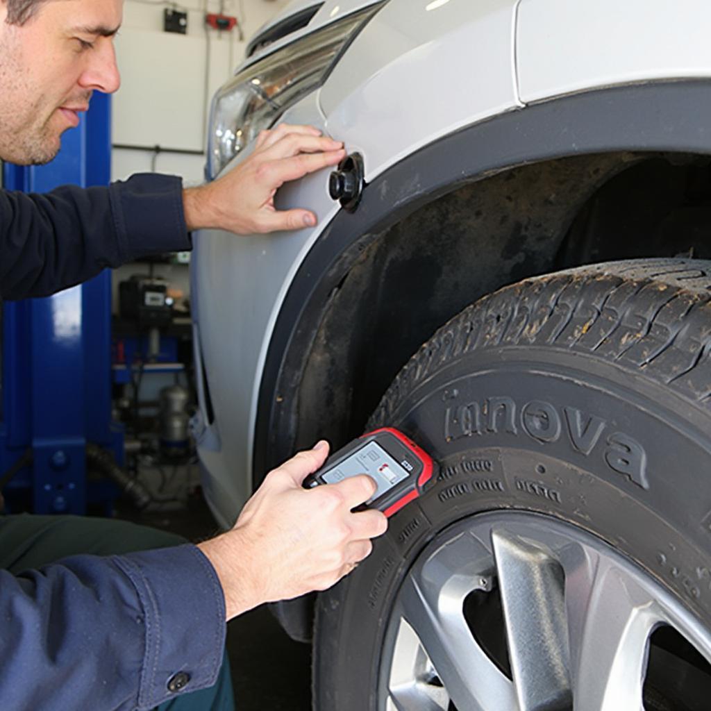 Mechanic Using Innova 5610 on a Vehicle