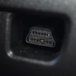 Close-up view of a Launch OBD2 connector plugged into a car's diagnostic port