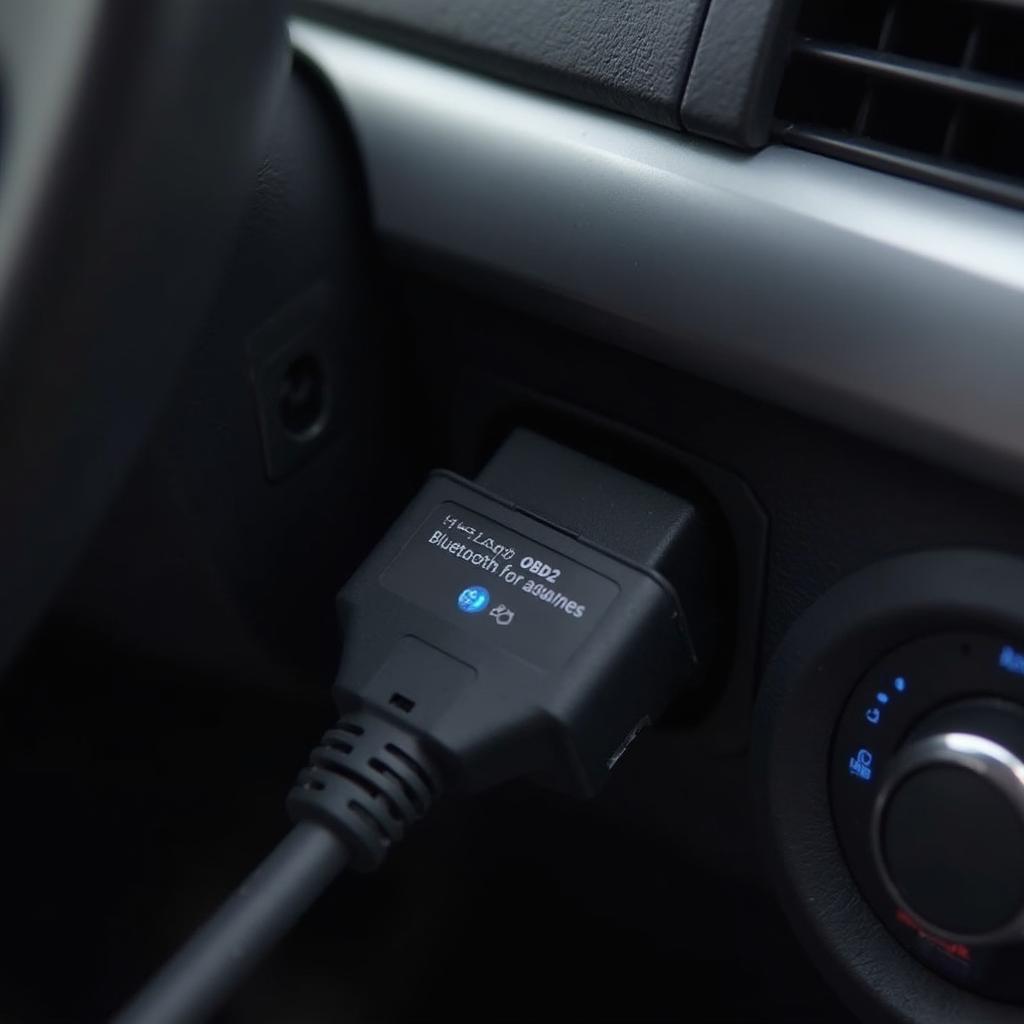 OBD2 Bluetooth Adapter Connected to Car OBD2 Port