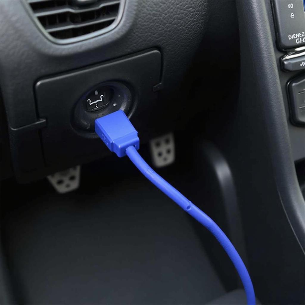 OBD2 Bluetooth cable plugged into a car's OBD2 port.