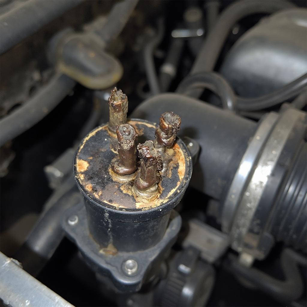 Damaged Ignition Coil Showing Signs of Wear and Tear