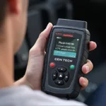 Holding the Cen Tech 98568 OBD2 Scanner