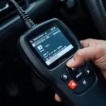 Mechanic using an OBD2 scanner to check transmission trouble codes in a car.