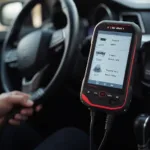 KW808 OBD2 Scanner being used to diagnose a car's engine.