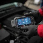 Mechanic Holding an OBD2 Scanner V319