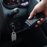 Reprogramming a key fob with OBD2 software connected to a car's OBD2 port.