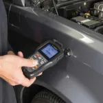 Mechanic Connecting OBD2 Scanner