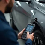 Mechanic Using Autophix OBD2 Scanner in a Workshop