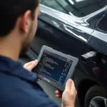 A mechanic using a super mini car wifi OBD2 scanner