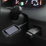 A USB OBD2 scan tool plugged into a car's diagnostic port.