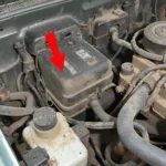 Close-up of the engine bay of an XJ Jeep, highlighting the location of the Engine Coolant Temperature (ECT) sensor.